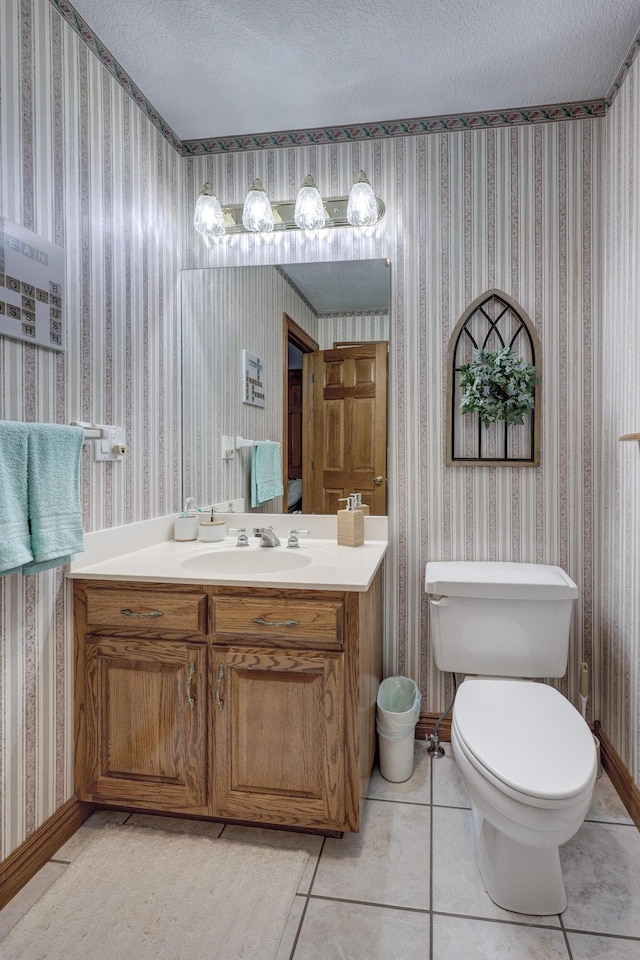 bathroom with vanity, a textured ceiling, toilet, and tile patterned flooring