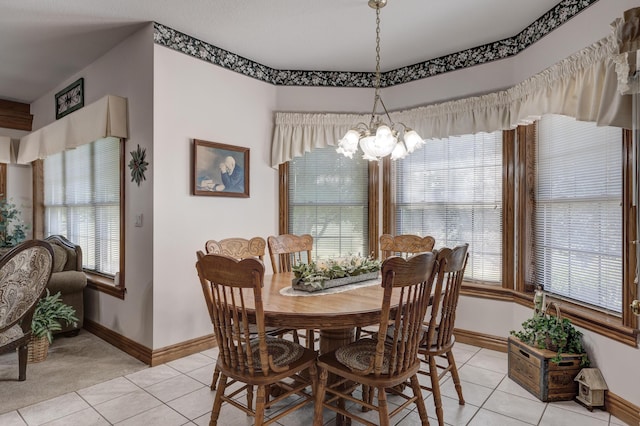 dining room with a chandelier and light tile patterned floors