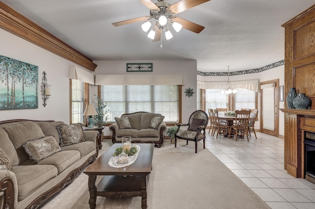 living room featuring a textured ceiling, ceiling fan with notable chandelier, and light tile patterned flooring