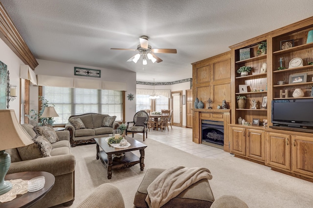 carpeted living room with ceiling fan with notable chandelier and a textured ceiling