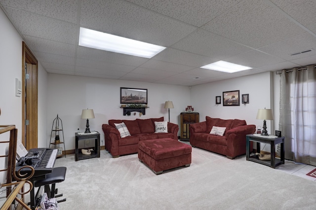 living room featuring a paneled ceiling and light colored carpet