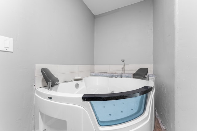 bathroom featuring a bath and vaulted ceiling