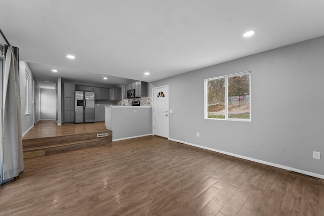 unfurnished living room with dark hardwood / wood-style flooring