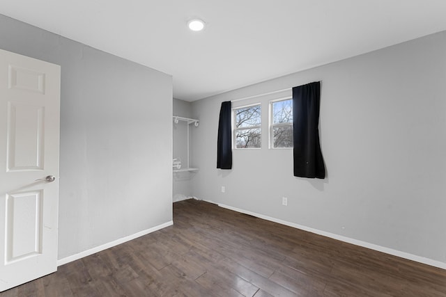 empty room with dark hardwood / wood-style floors