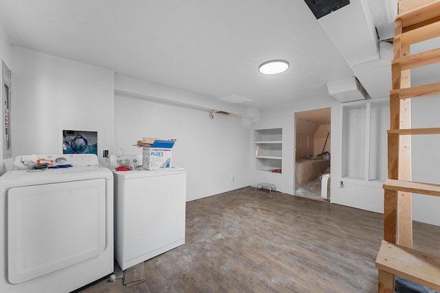 laundry room featuring built in shelves, dark hardwood / wood-style flooring, and separate washer and dryer