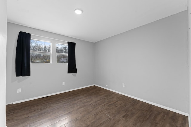 spare room featuring dark wood-type flooring