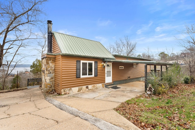 29 Adams Ln, Blue Eye, MO 65611 - rustic home featuring asphalt driveway, a metal roof, a chimney, log veneer siding, and stone siding