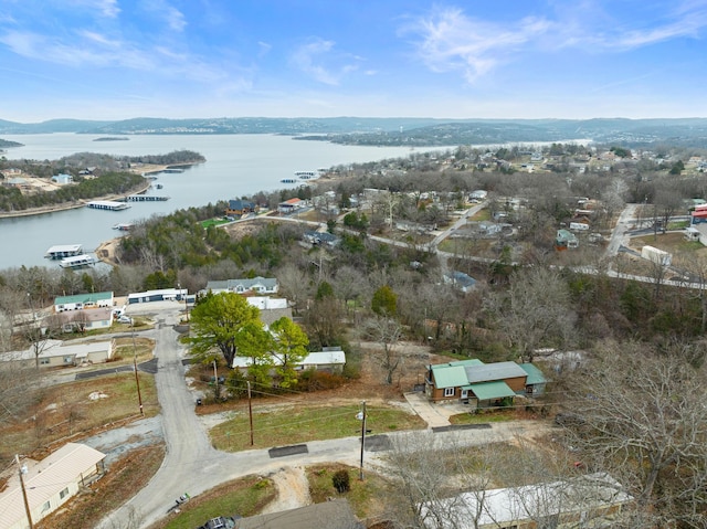 birds eye view of property with a water and mountain view