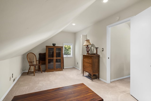 bonus room with light colored carpet and lofted ceiling