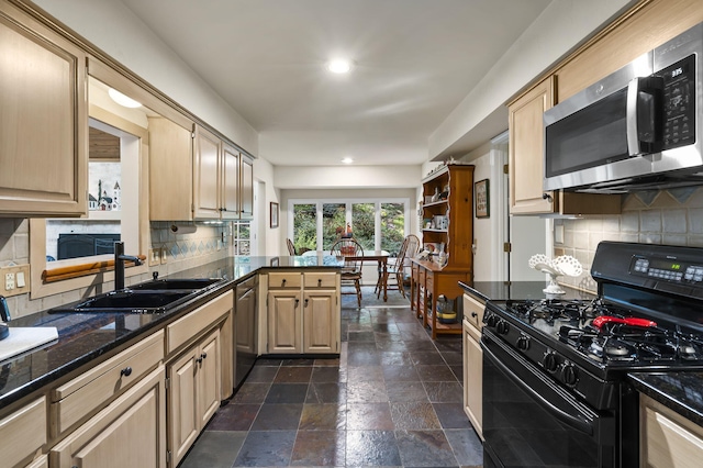 kitchen featuring decorative backsplash, light brown cabinets, stainless steel appliances, and sink