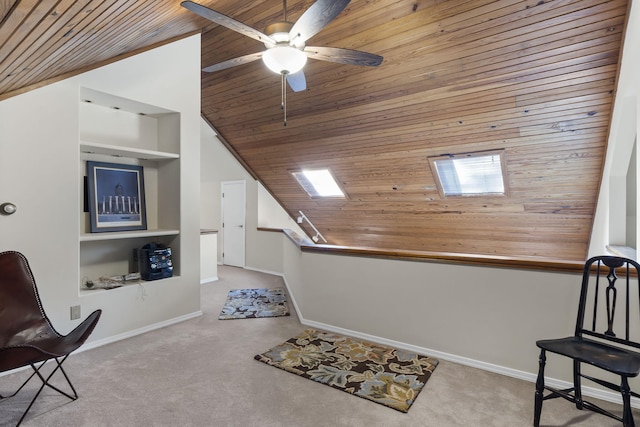 sitting room with ceiling fan, built in features, light carpet, and wooden ceiling