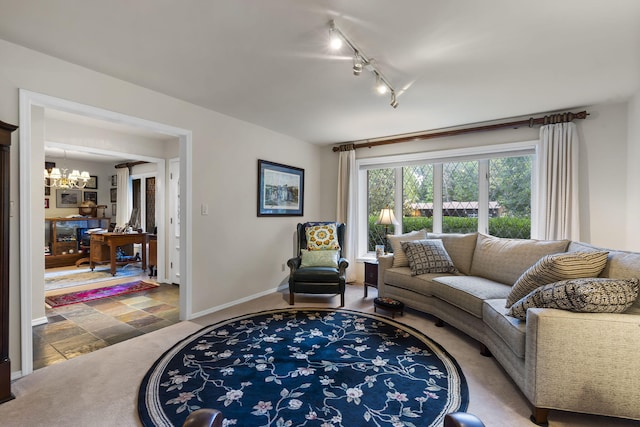 living room with track lighting and a notable chandelier