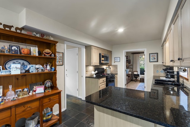 kitchen featuring kitchen peninsula, black range with gas stovetop, decorative backsplash, and cream cabinets