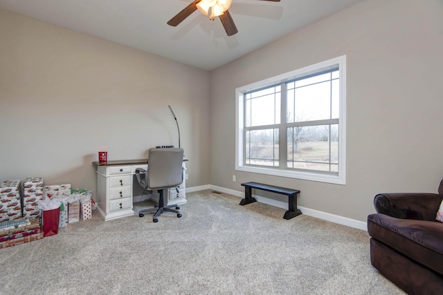 carpeted office space with ceiling fan