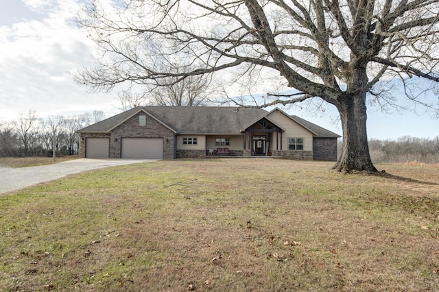 single story home featuring a garage and a front lawn