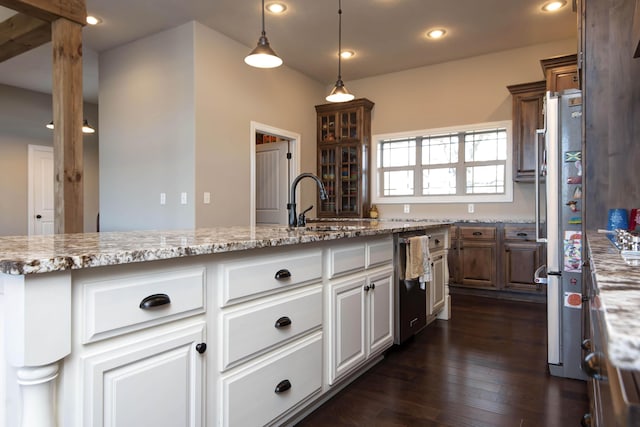 kitchen with dark hardwood / wood-style flooring, stainless steel appliances, sink, pendant lighting, and white cabinets