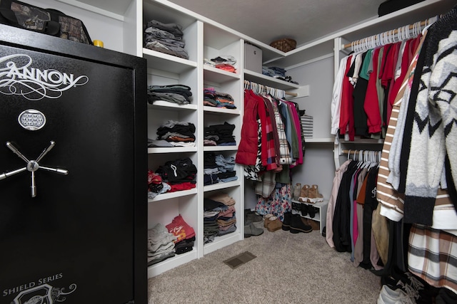 walk in closet with carpet floors