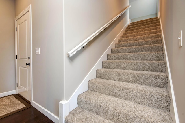 stairway with hardwood / wood-style flooring