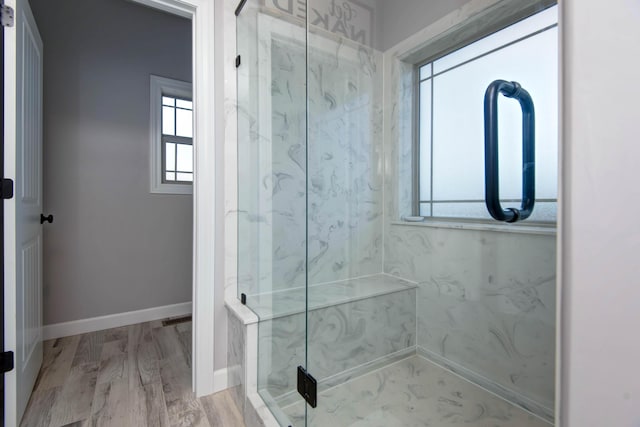 bathroom featuring hardwood / wood-style floors and a shower with door