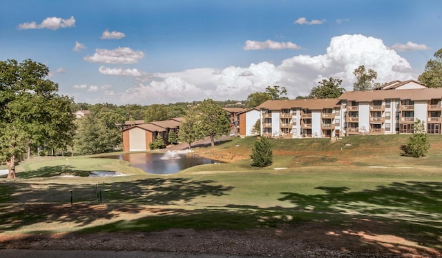 view of community with a lawn and a water view