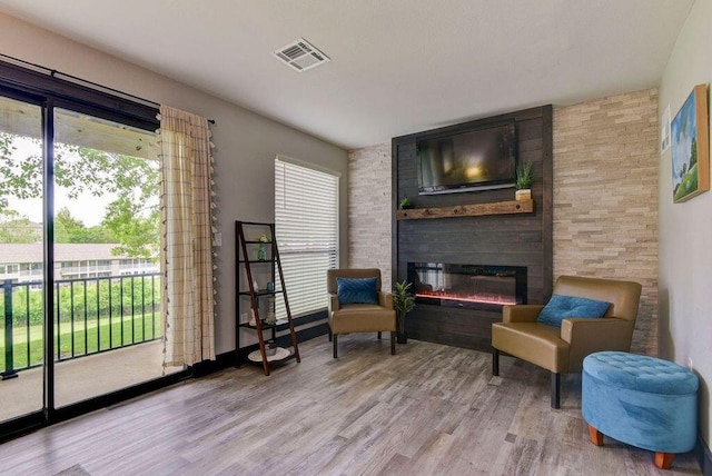 sitting room featuring light wood-type flooring and a fireplace