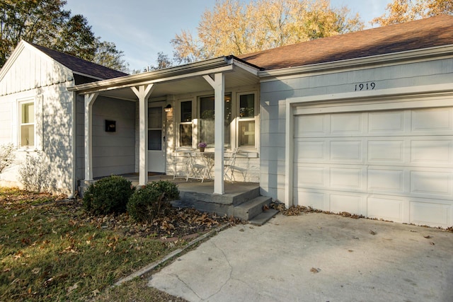 ranch-style house with a porch and a garage