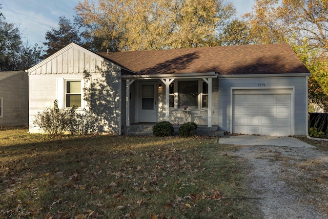 ranch-style house featuring a front yard and a garage