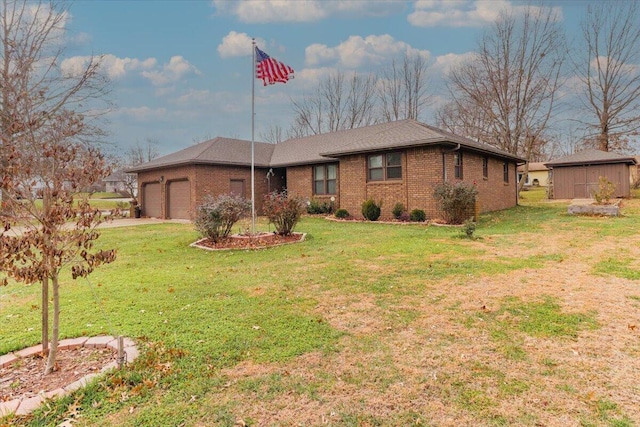 ranch-style home featuring a storage unit, a garage, and a front yard