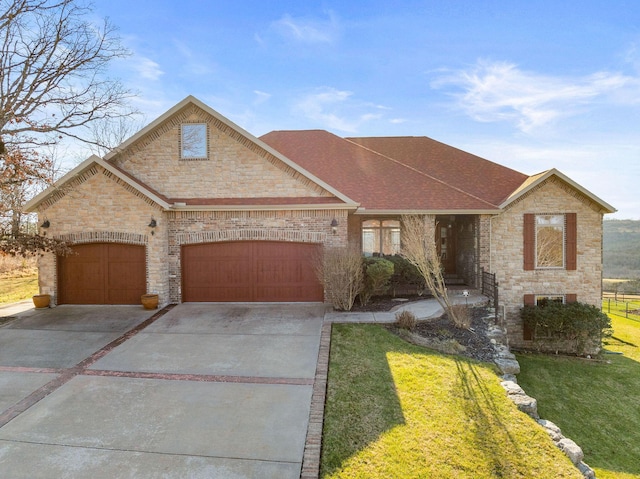 view of front facade with a front yard and a garage