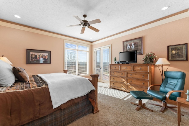 bedroom with ceiling fan, a textured ceiling, crown molding, and carpet