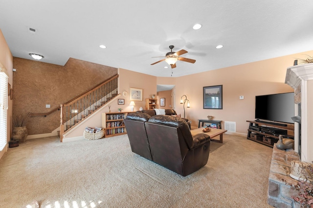 living room with ceiling fan and light colored carpet