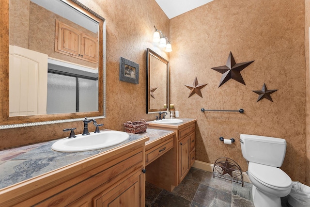 bathroom featuring toilet and vanity