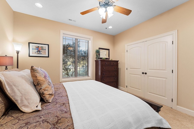 bedroom with ceiling fan, a closet, and carpet floors