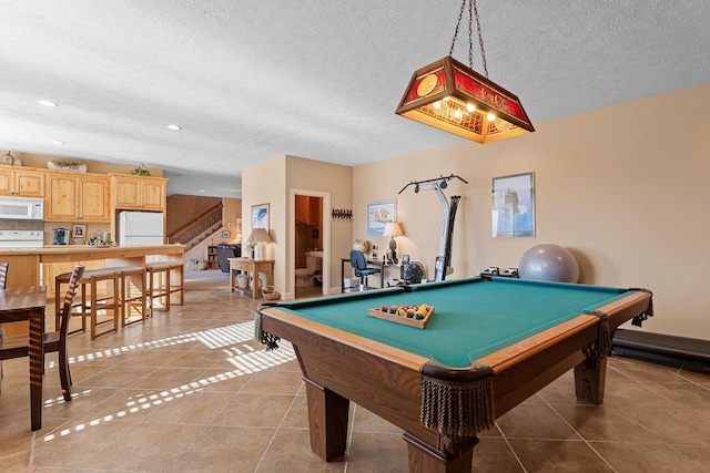 playroom with a textured ceiling, light tile patterned floors, and billiards