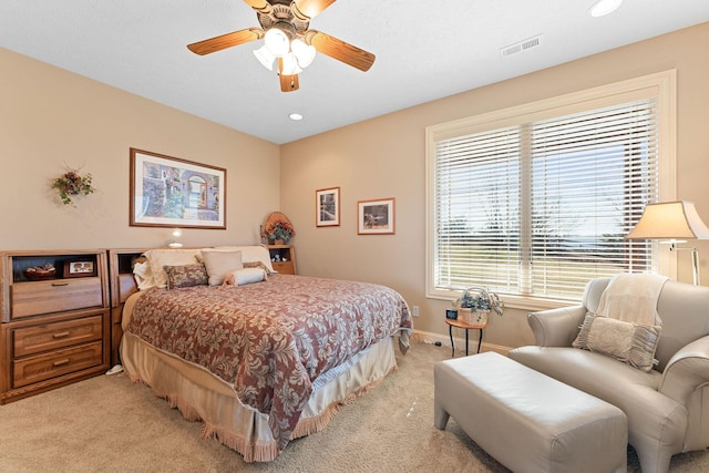 bedroom featuring ceiling fan and light carpet