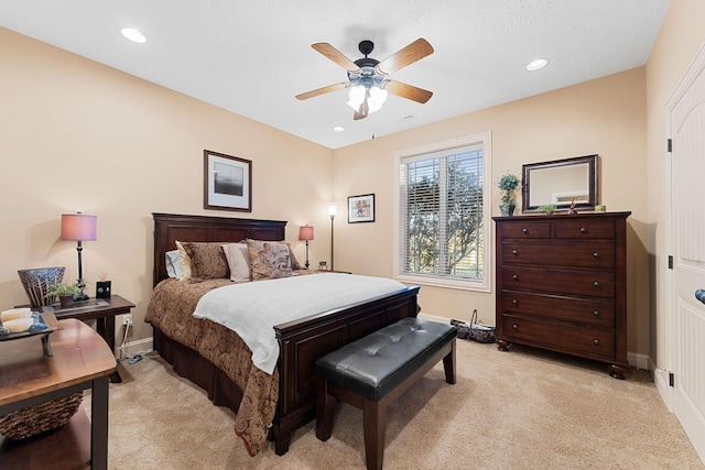 bedroom featuring ceiling fan and light colored carpet