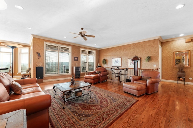 living room with ceiling fan, crown molding, and hardwood / wood-style floors