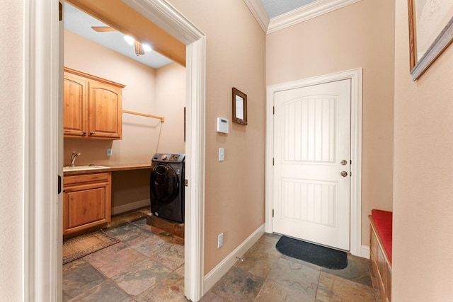 entryway with washer / clothes dryer, sink, and crown molding