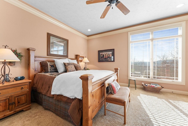 carpeted bedroom with a textured ceiling, ceiling fan, and ornamental molding