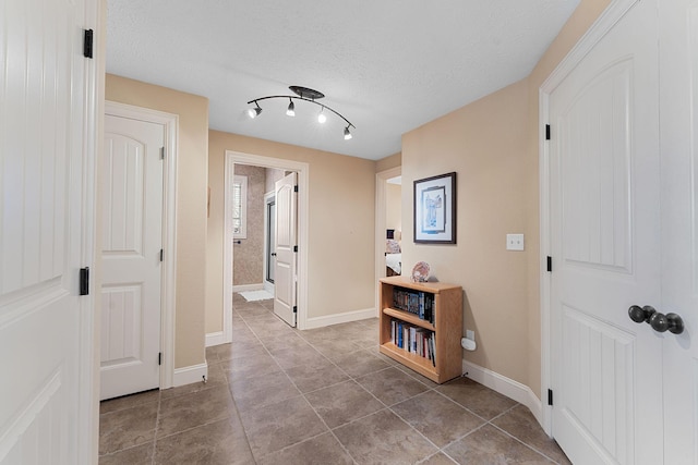 corridor featuring a textured ceiling