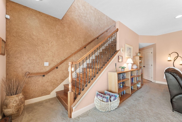 stairs featuring carpet flooring