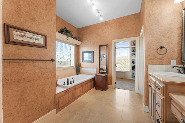 bathroom with a bath and vanity