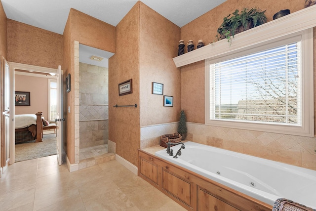 bathroom with tile patterned flooring and shower with separate bathtub