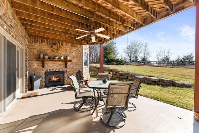 view of patio / terrace with ceiling fan and an outdoor stone fireplace