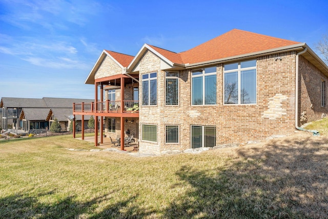 back of house featuring a wooden deck and a yard