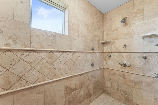 bathroom with a tile shower