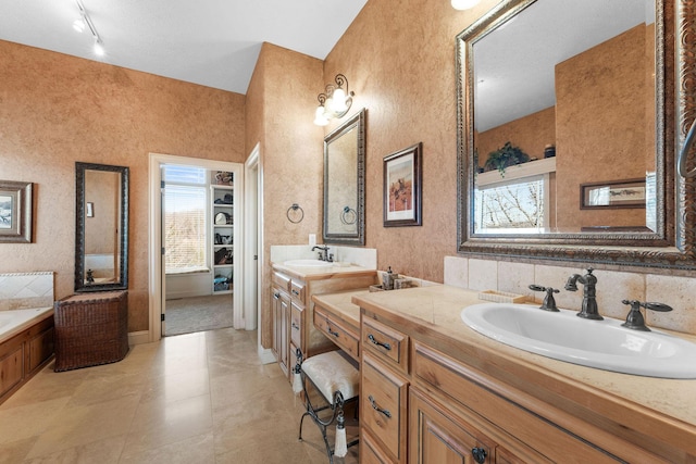 bathroom featuring a washtub and vanity