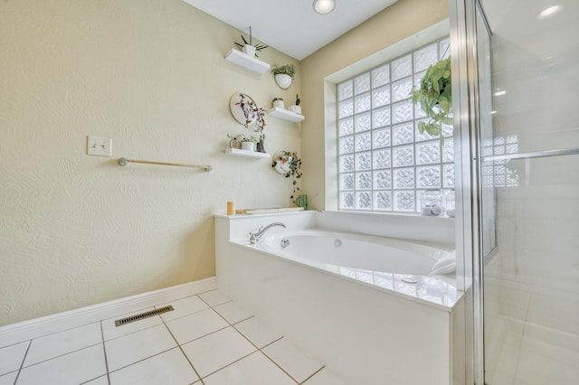 bathroom with separate shower and tub, a wealth of natural light, and tile patterned flooring