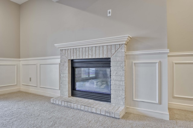 details with carpet and a brick fireplace