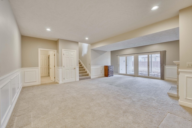 unfurnished living room with light colored carpet